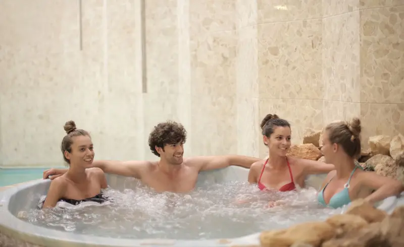 Friends relaxing together in a bubbling hot tub Aquafun Sheffield